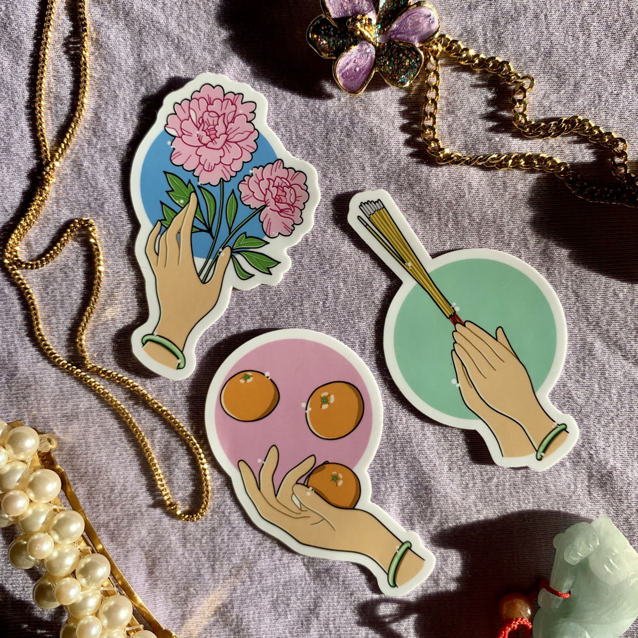 Three stickers on a light purple background, surrounded by pieces of jewellery. Each sticker depicts a hand wearing a green bracelet in various poses.